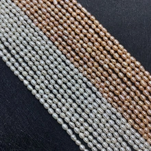 Detailed view of white and pink natural freshwater rice-shaped pearl strands for jewelry