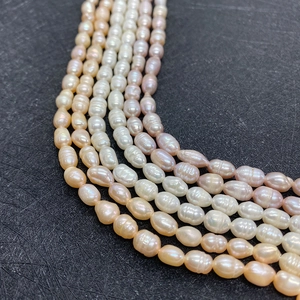 Macro shot of natural freshwater rice pearls in white, pink and orange-pink colors