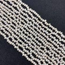 Detailed macro view of multiple strands of 4-5mm natural white freshwater seed pearls