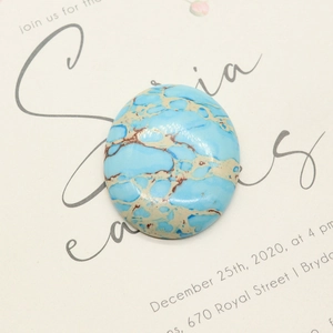 Polished oval blue turquoise gemstone cabochon with natural brown web pattern