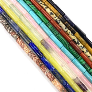 Detailed close-up of mixed natural semi-precious stone bamboo cylinder beads for DIY jewelry