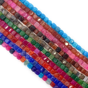 Macro view of colorful polished square natural stone beads in various vibrant shades