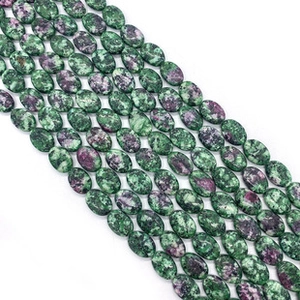 Macro detail of polished ruby zoisite heart-shaped oval beads for jewelry DIY