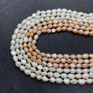 Detailed close-up of natural white and pink irregular baroque freshwater pearls for DIY jewelry