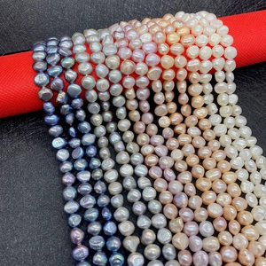 Close-up of assorted natural freshwater pearls in peacock blue and silver grey