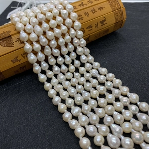Strands of 8-9mm natural white Edison pearls with strong luster on vintage bamboo