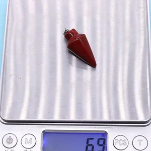 Macro shot of 6.9g bullet-shaped red jasper stone pendant with silver metal clasp