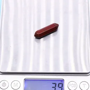 Macro shot of a 3.9g red jasper hexagonal pendant on a digital scale showing its weight