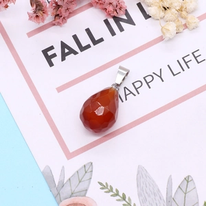 Faceted teardrop natural stone pendant displayed on a stylish card with floral accents