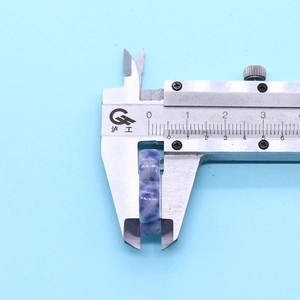 Detailed caliper measurement showing the 7-8mm thickness of the blue sodalite stone bead