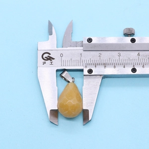 Faceted teardrop gemstone pendant measured with calipers for size accuracy
