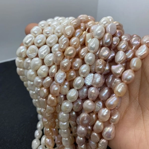 Detailed close-up of mixed natural baroque pearls in white, pink, and purple shades