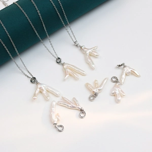 Handmade sterling silver necklaces with unique claw-shaped baroque pearls and zircon accents