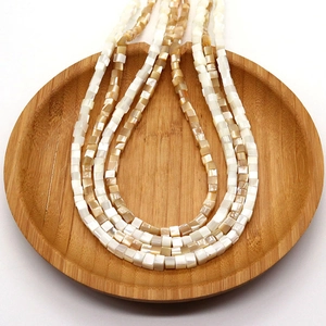 Natural square seashell beads on a wooden tray for DIY necklace and jewelry making
