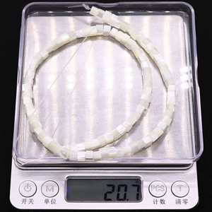 Detailed scale view of 20.7g natural white seashell square beads with pearl luster