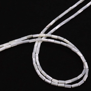 Detailed macro view of natural cylindrical sea shell beads with iridescent pearl luster