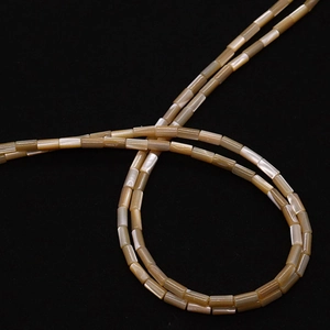 Macro detail of cylindrical shell beads with natural luster for DIY jewelry making