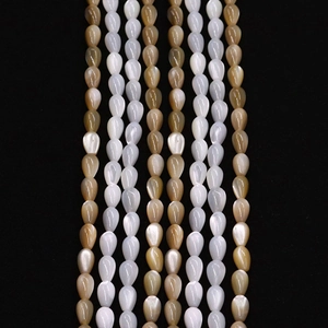 Vertical strings of teardrop natural shell beads in cream and amber for DIY jewelry