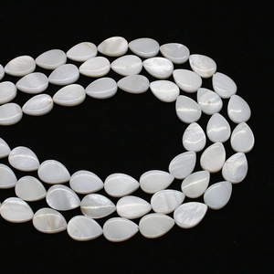 Macro view of teardrop white mother of pearl shell beads with natural iridescence