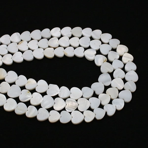 Macro detail of moon shaped natural shell beads with iridescent luster for DIY jewelry