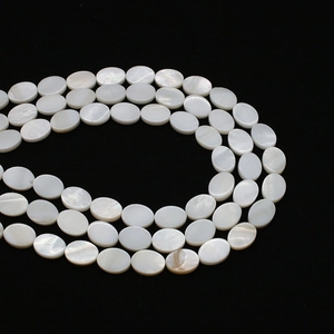 Macro shot of oval white mother of pearl loose beads with natural iridescent luster for DIY