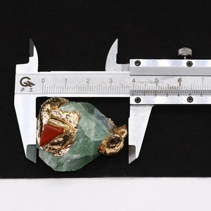 Vue détaillée d'un pendentif en pierre naturelle verte avec placage or et mesure