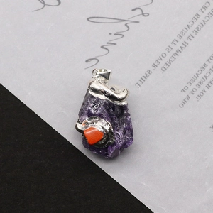 Macro detail of natural irregular purple amethyst pendant with silver metallic accents