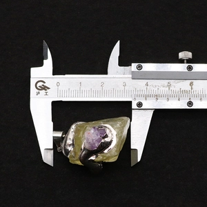 Detail showing irregular raw natural stone pendant width measurement with a caliper