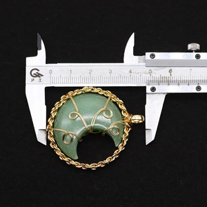 Macro shot measuring the crescent moon gemstone pendant with a digital caliper, size 45mm