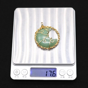 Green aventurine moon pendant with gold wire wrap on scale weighing 17.6g