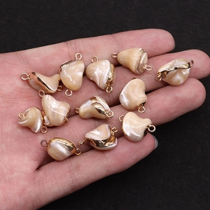 Natural heart-shaped seashell charm with gold trim and double connectors for DIY jewelry