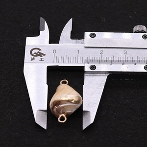 Detail shot of natural shell connector with gold accents measured at 14mm width