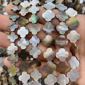 Macro shot of natural mother of pearl shell clover beads with iridescent luster for DIY