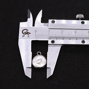 Detailed view of 10mm round freshwater pearl pendant measured with digital caliper