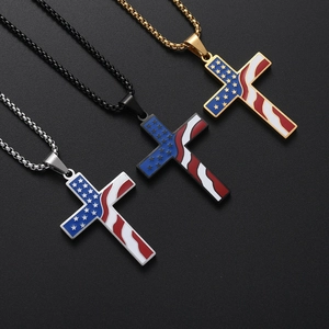 Detailed close-up of three enamel cross pendants with US flag motifs in gold, silver, and black