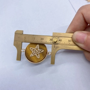 Detailed view of tiger eye stone pendant with golden starfish and 25mm measurement