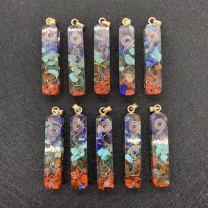 Rectangular resin chakra pendant with layered natural stones and golden wire spiral