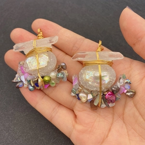 Handmade wire-wrapped freshwater pearl and iridescent crystal pendant in gold finish