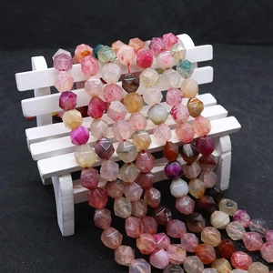 Macro detail of faceted dragon vein agate beads with colorful natural stone textures