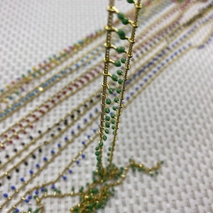 Detail of colorful enamel bead metal chain rolls for DIY jewelry necklaces and bracelets