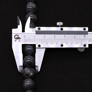 Detail view of 8mm natural labradorite beads measured with a digital caliper