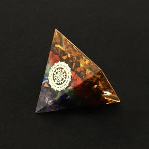 Macro detail of Orgone Pyramid featuring Sri Yantra symbol and layered natural stones