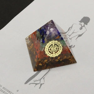 Orgone crystal pyramid with tiger eye stones and Sri Yantra sacred geometry symbol