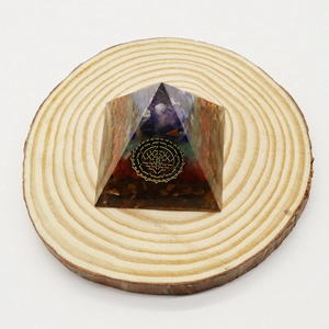 Tiger eye stone orgo pyramid with resin sacred geometry pattern on wooden base