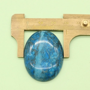 Detail showing measurement of 30mm blue oval natural stone bead with a caliper tool