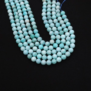 Macro detail of light blue Amazonite round beads showing natural mineral textures