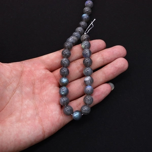 Macro shot of natural labradorite round beads with blue and green spectral flashes