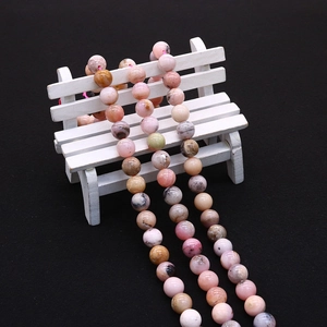 Detail of multi-color natural stone beads in round shape with polished surface on a prop