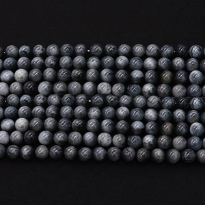Perle in pietra naturale di labradorite grigia lucida disposte per bigiotteria