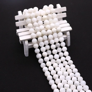 Detailed close-up of polished white moonstone round beads for DIY jewelry making